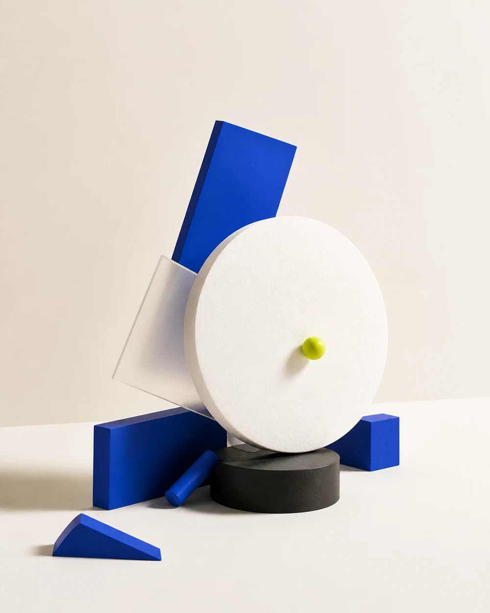 Cobalt, paper and acid-green geometric forms arranged in balance